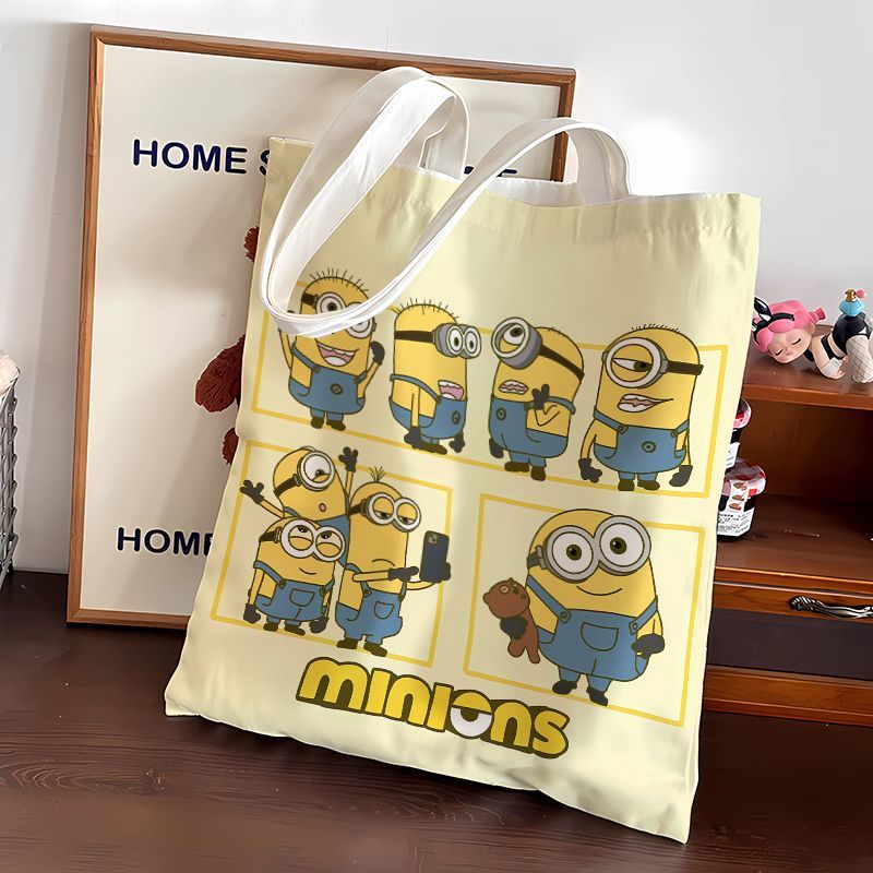 Canvas Tote Bag - กระเป๋าผ้าแคนวาสลายการ์ตูนมินเนี่ยนน่ารัก กระเป๋าสะพายสำหรับนักเรียน กระเป๋าช้อปปิ้งพกพา กระเป๋าสะพายไหล่ ของขวัญ ขายส่ง